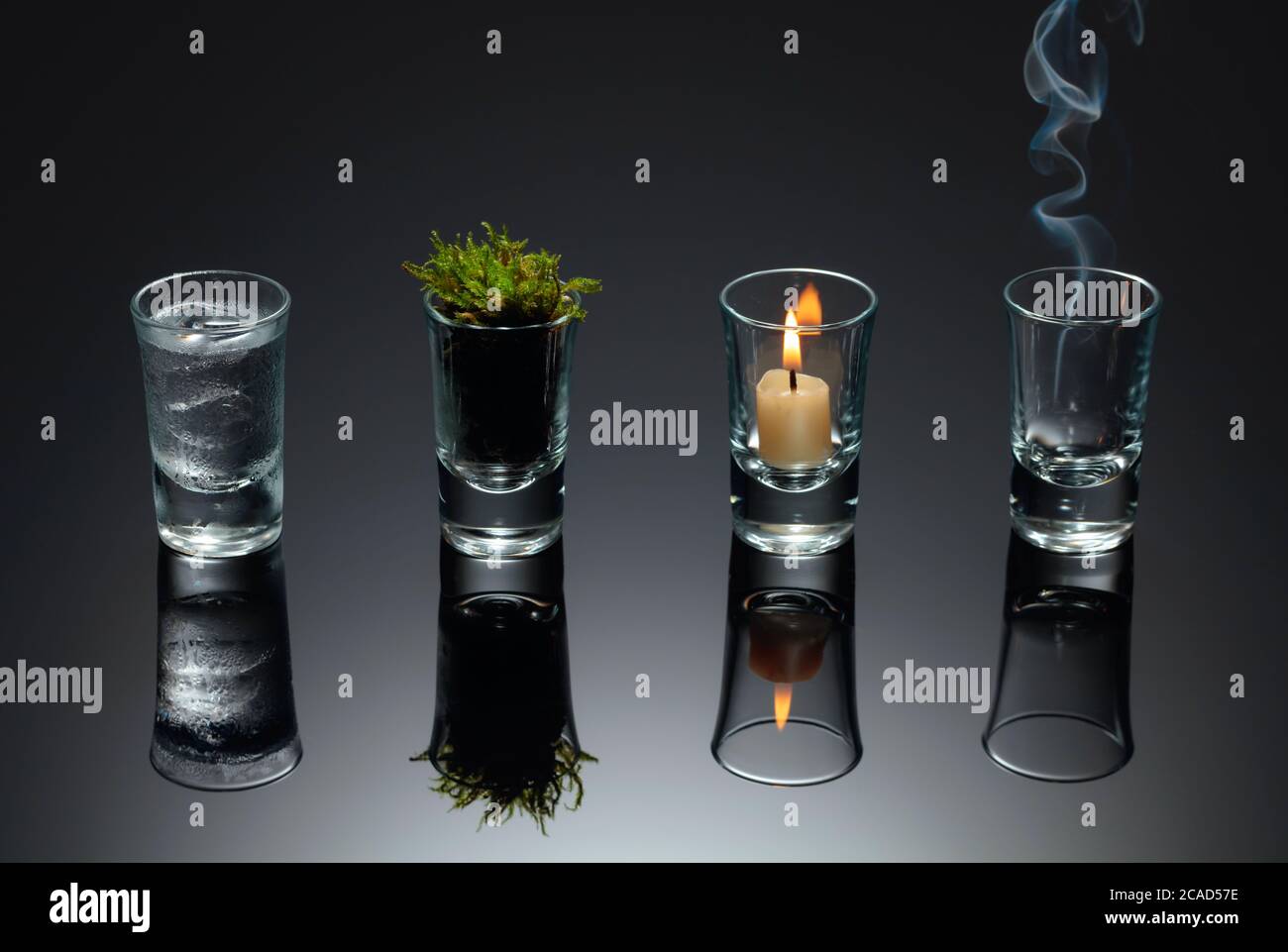 Four elements of nature - air, fire, earth, water. Four elements concept in  glasses on a black reflective background Stock Photo - Alamy