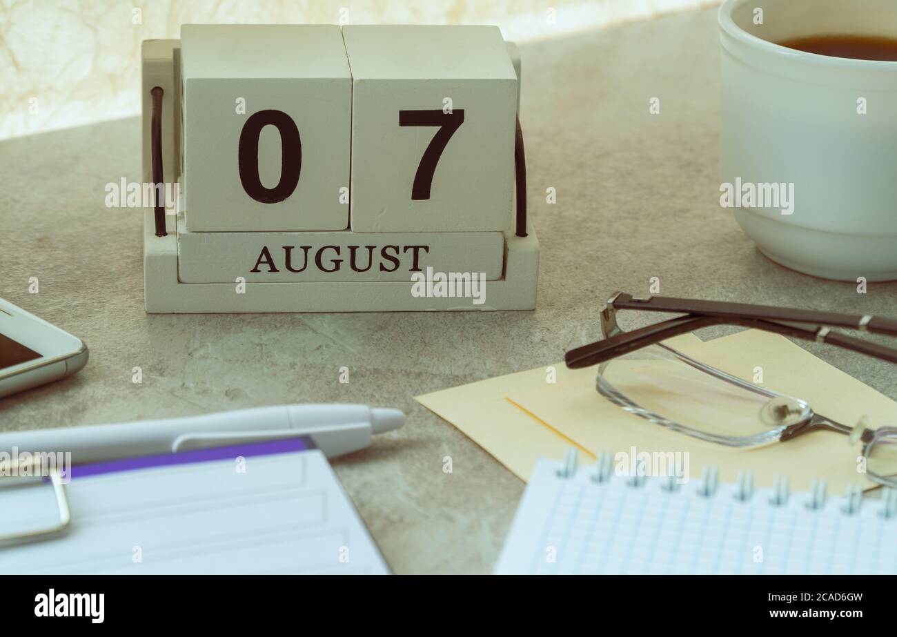 August 07, date on the calendar. Handmade wood cube with date month and ...