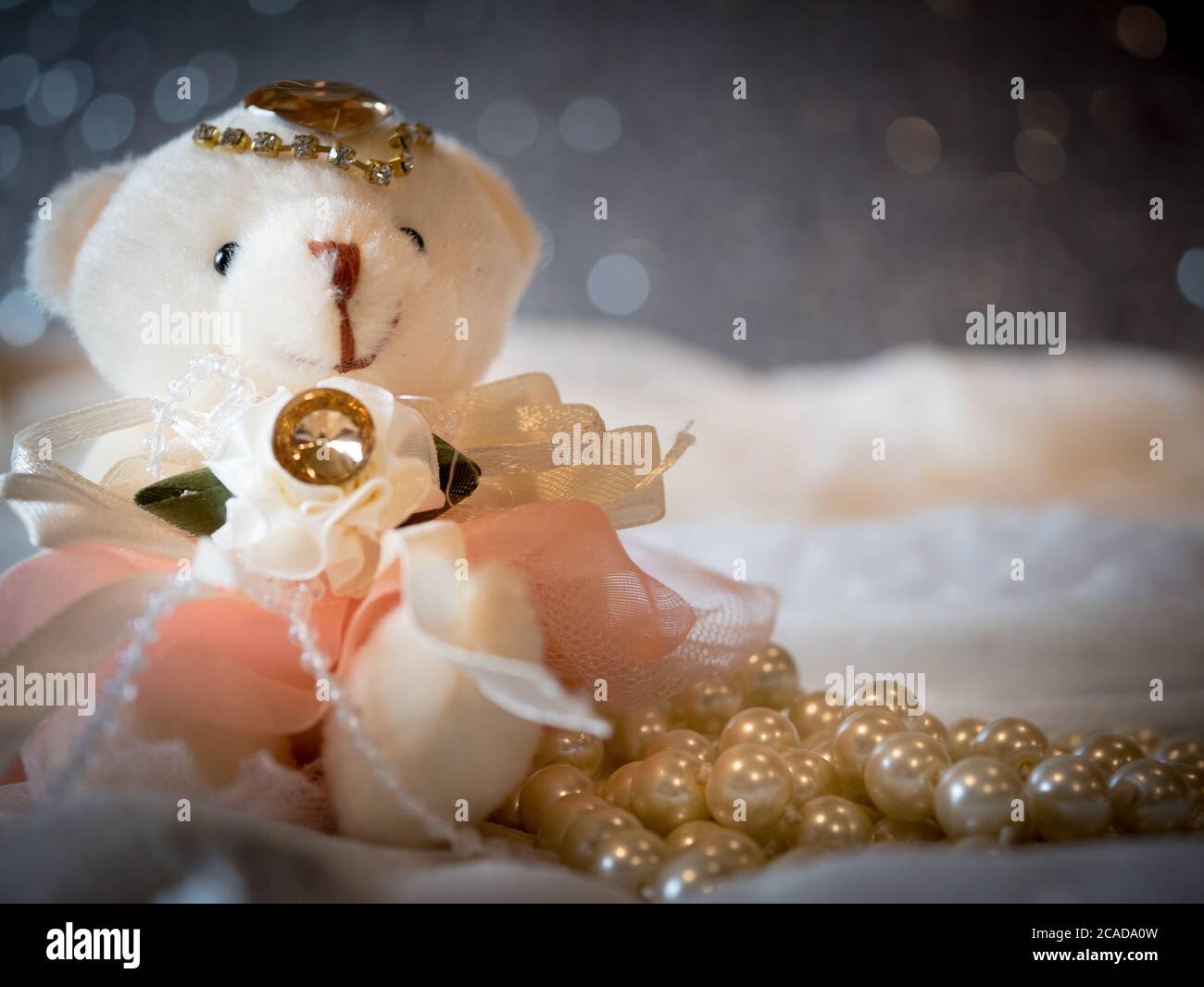 Bear doll bride wearing wedding dress on luxury background decoration and beautiful bokeh. wedding card greeting concept for lovely theme. Stock Photo