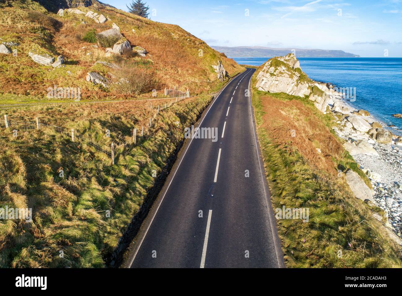 Causeway Coastal Route a.k.a Antrim Coast Road A2 on the Atlantic coast in Northern Ireland. One of the most scenic coastal roads in Europe. Aerial vi Stock Photo