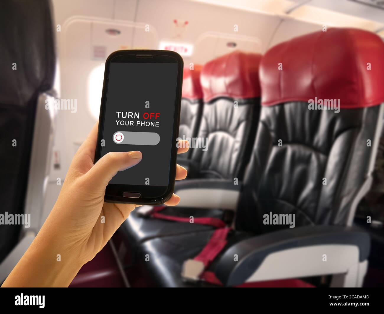 In-flight Security concept. Passenger turn off portable electronic devices and mobile phone or use flight mode on airplane aboard airliners between fl Stock Photo