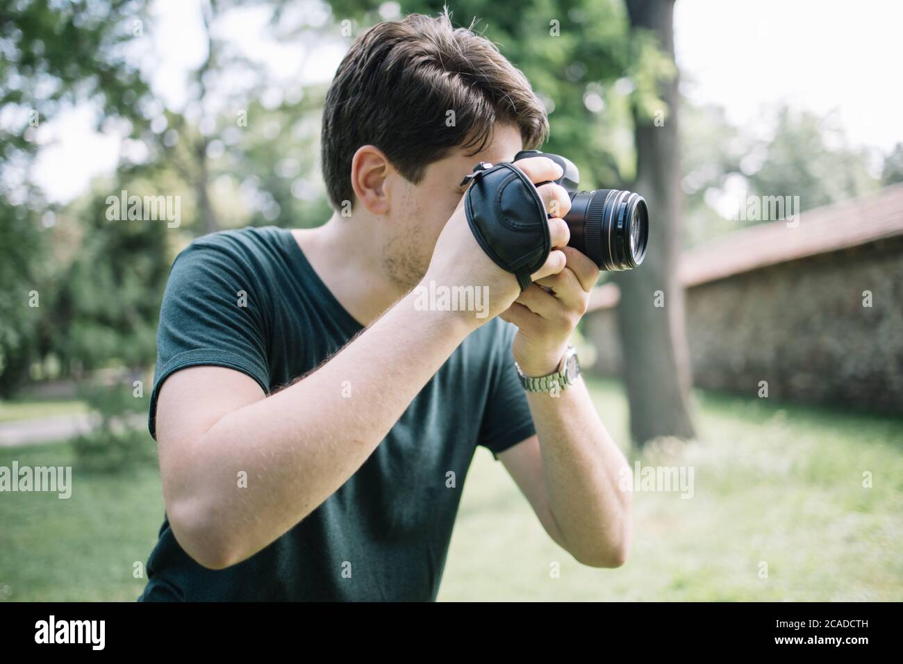 Portrait of man looking through camera viewfinder Stock Photo Alamy