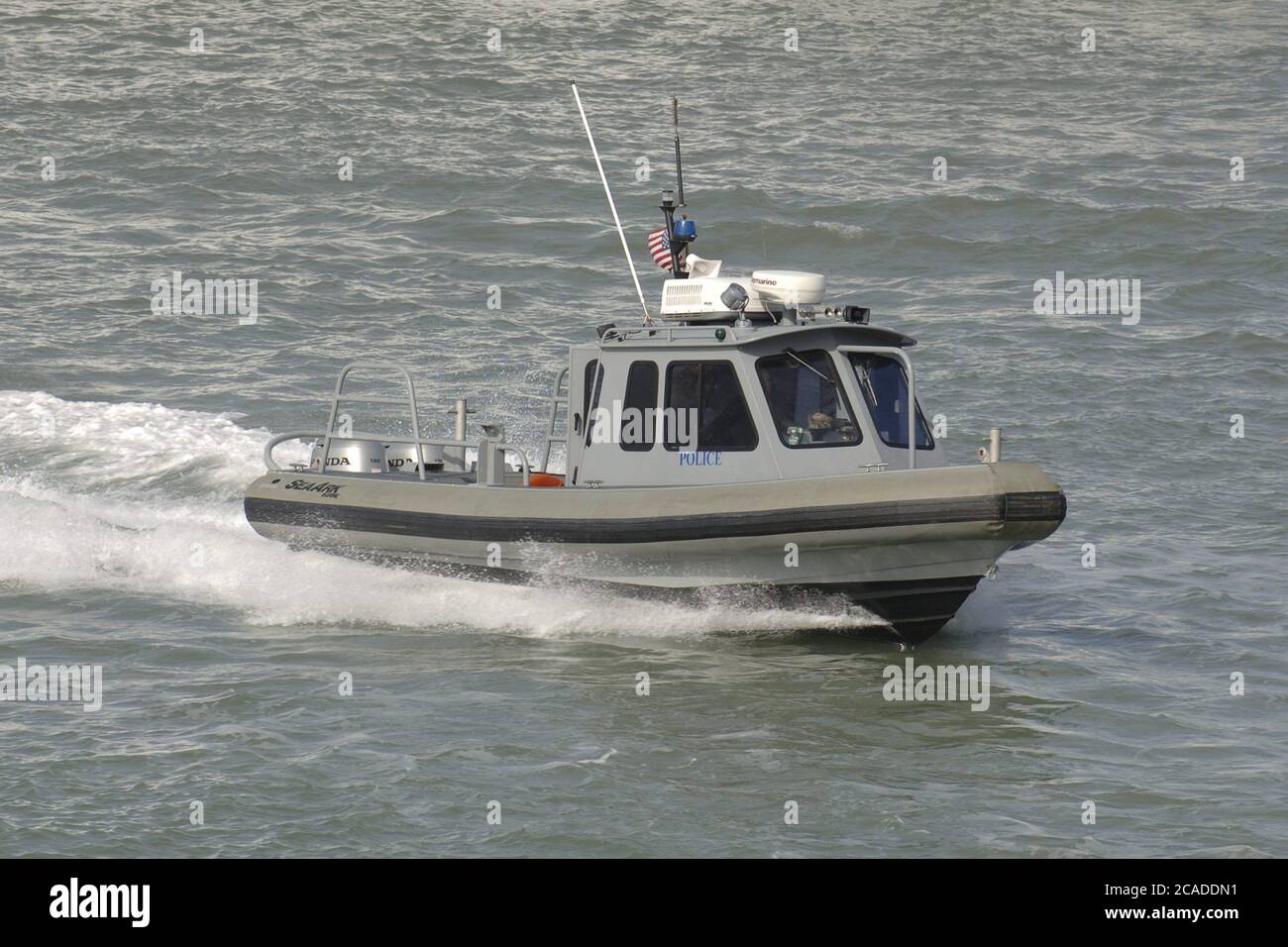 Port Aransas, Texas USA, January 15, 2006:  A harbor police boat works the Aransas Channel into Corpus Christi Bay on the Texas Gulf coast  ©Bob Daemmrich Stock Photo