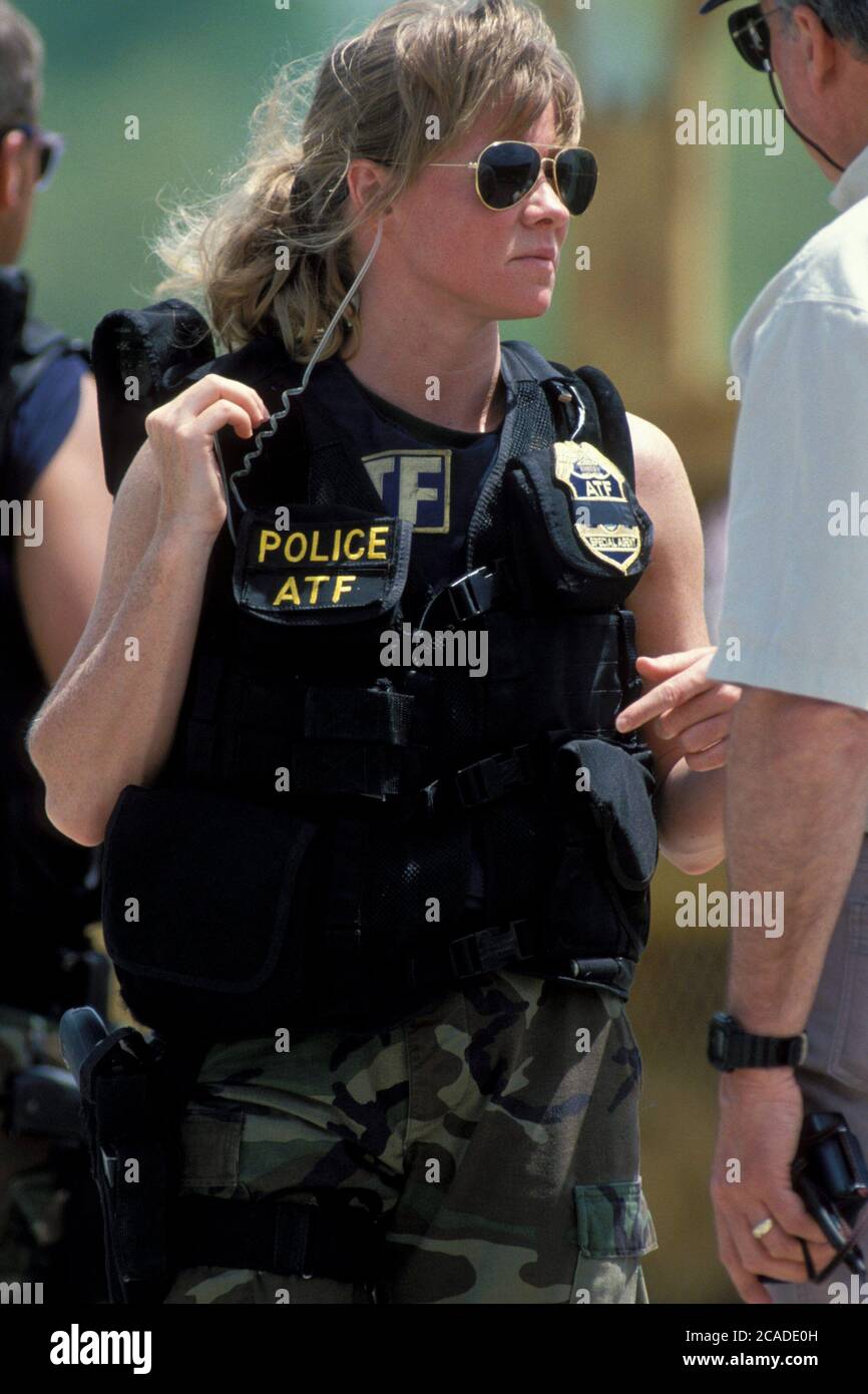 Waco, Texas USA, April 1993: Female officer with the federal Bureau of Alcohol, Tobacco and Firearms (ATF) at standoff between law enforcement agents and the Branch Davidian members 'Students of the Seven Seals.'  ©Bob Daemmrich Stock Photo