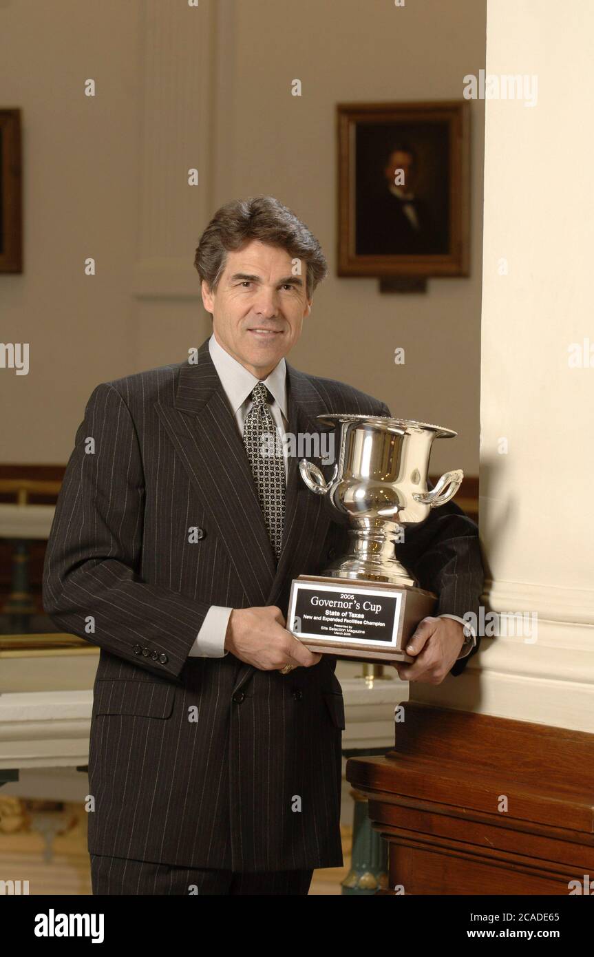Austin Texas USA, March 6, 2006:  Texas Governor Rick Perry, in the rotunda of the State Capitol, holds the Governor's Cup given to him by Site Selection Magazine for the state with the most job creations reported in the United States for 2005. ©Bob Daemmrich Stock Photo