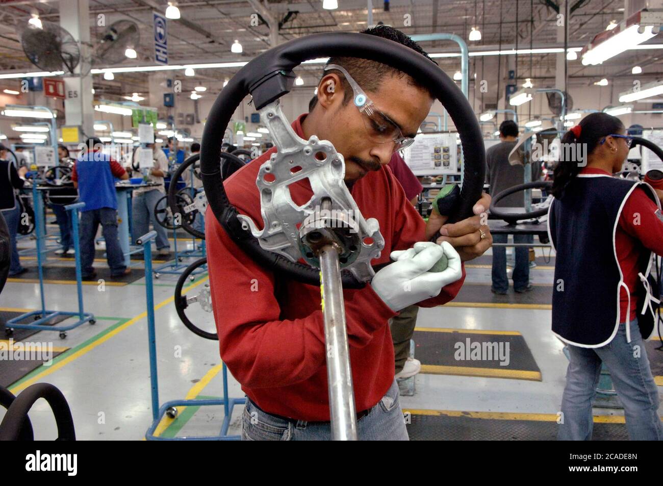 Matamoros, Mexico April, 2006: Steering wheel manufacturing at Delphi Delco Electronics de Mexico, a maquiladora plant across the United States border from Brownsville Texas that makes parts for General Motors cars. Delphi has about 11,000 Mexican workers in seven factories near Matamoros. ©Bob Daemmrich Stock Photo