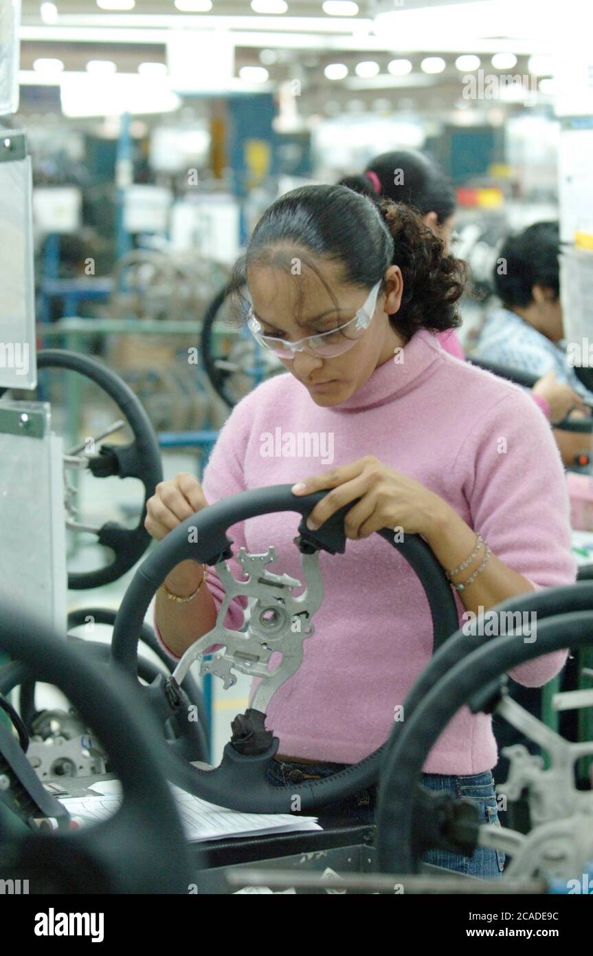 Matamoros, Mexico April, 2006: Steering wheel manufacturing at Delphi Delco Electronics de Mexico, a maquiladora plant across the United States border from Brownsville Texas that makes parts for General Motors cars. Delphi has about 11,000 Mexican workers in seven factories near Matamoros. ©Bob Daemmrich Stock Photo