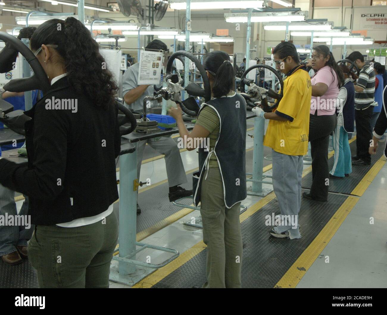 Matamoros, Mexico April, 2006: Steering wheel manufacturing at Delphi Delco Electronics de Mexico, a maquiladora plant across the United States border from Brownsville Texas that makes parts for General Motors cars. Delphi has about 11,000 Mexican workers in seven factories near Matamoros. ©Bob Daemmrich Stock Photo