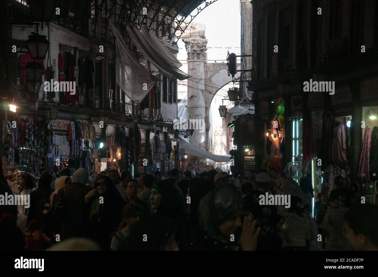 Syrian shoppers walk through the busy and crowded al Hamidiyah market, a typical Middle Eastern souq in the old city of Damascus, Syria. Stock Photo