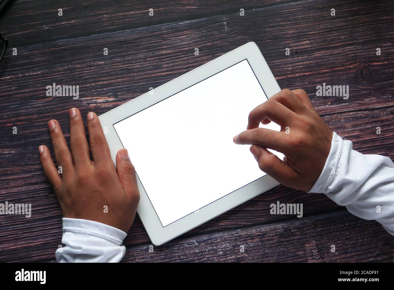 man hand using digital tablet displaying white screen top down  Stock Photo