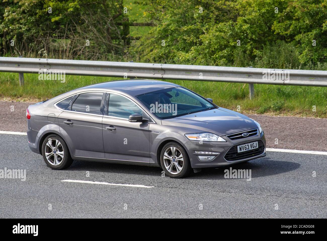 2013 grey Ford Mondeo Titanium X B-S EDN; Vehicular traffic moving vehicles, cars driving vehicle on UK roads, motors, motoring on the M6 motorway highway network. Stock Photo