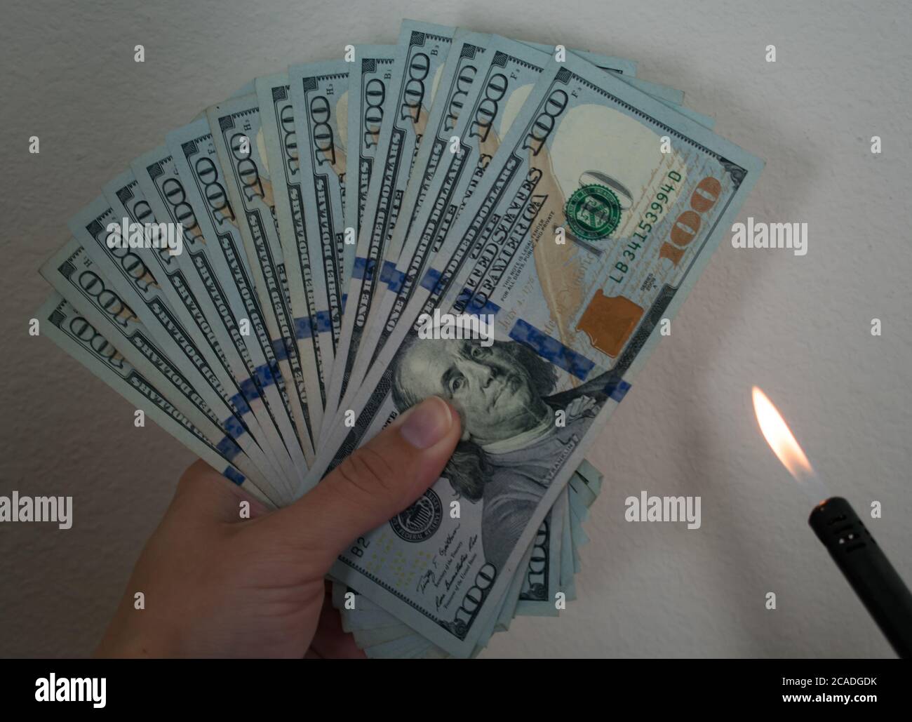 Burning Money Motif Fanned Hundred dollar bills with Fire and LIghter
