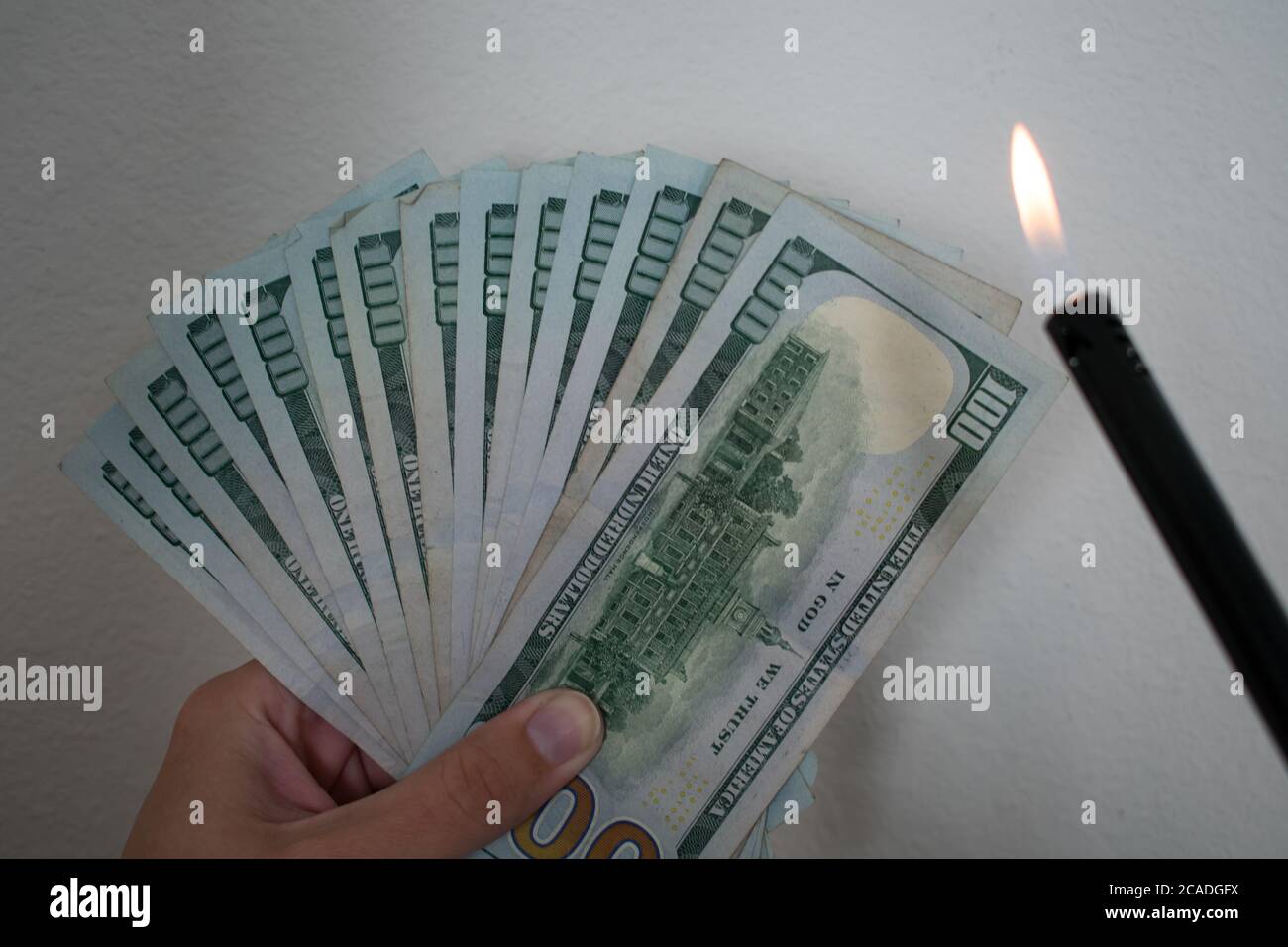 Burning Money Motif Fanned Hundred dollar bills with Fire and LIghter
