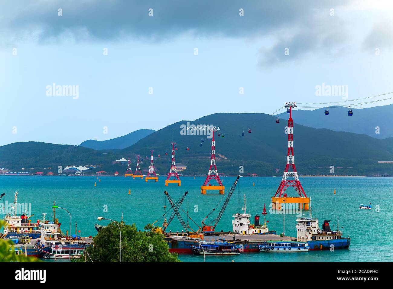 NHA TRANG, VIETNAM - FEB 12, 2015: Cable car tower to Vin pearl Amusement Park Island Scenic Colorful Sky At Sunset Dawn Sunrise, cableway long rope r Stock Photo