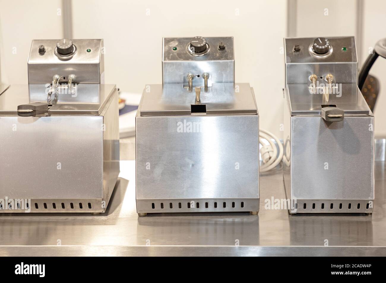 Commercial Deep Frier Machines in Restaurant Kitchen Stock Photo