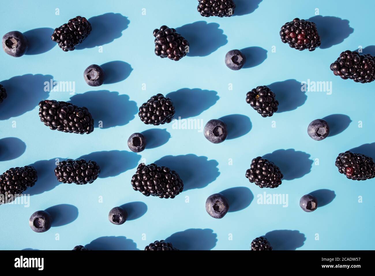 Fresh summer pattern with berries on blue table Stock Photo
