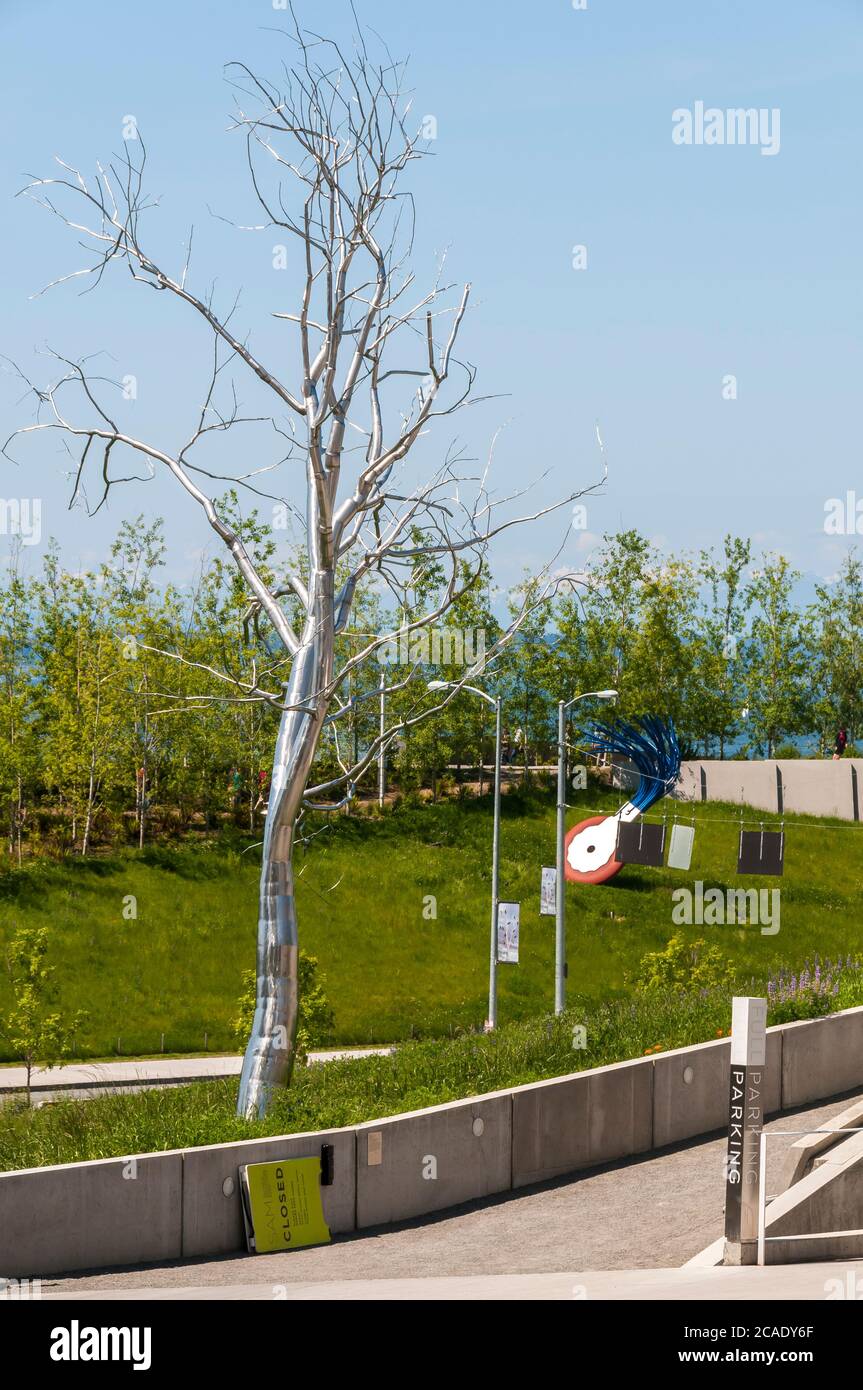 Large sculpture of wheel typewriter eraser with brush and a metal tree