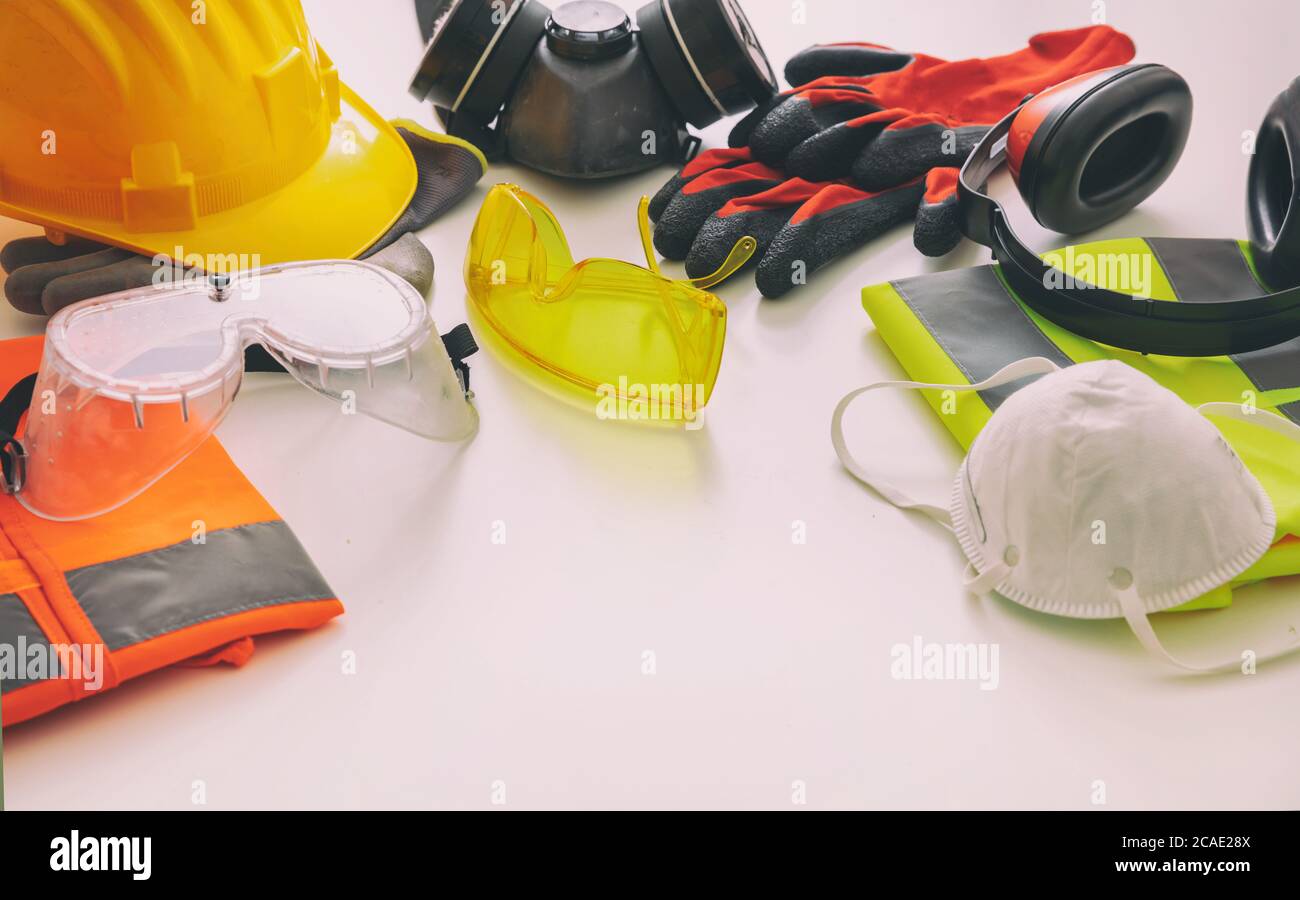 Work safety protection equipment flat lay. Industrial protective gear on white background, closeup view. Construction site health and safety concept Stock Photo