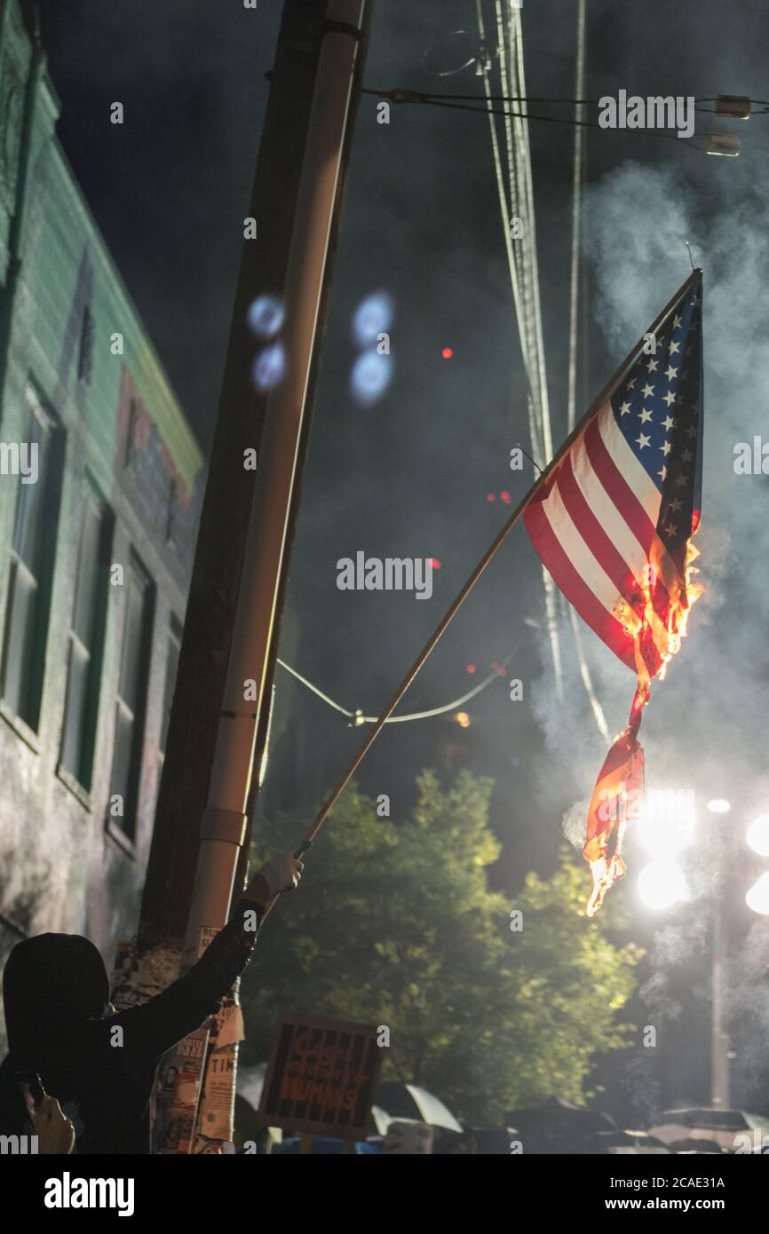 Seattle Usa Jun 7 2020 A Protestor Burning A American Flag On Capitol Hill At The Autonomous Zone Early In The Evening Stock Photo Alamy
