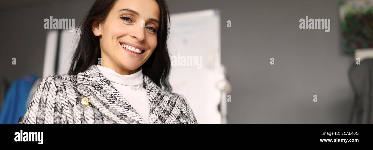 Happy girl sitting in office at table and smiling Stock Photo - Alamy
