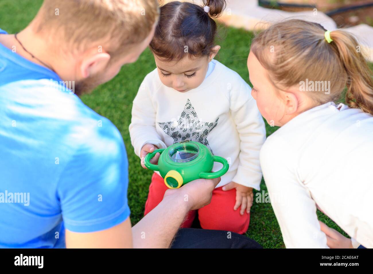 The father shows the caterpillar to the kids.Bearded dad with children in  summer garden. Man teacher with children in nature class. A lesson about  insects Stock Photo - Alamy