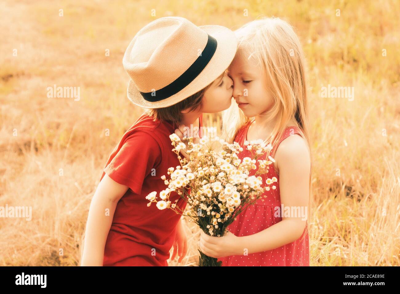 Happy lovely kids kiss on autumn field. Cute little children ...