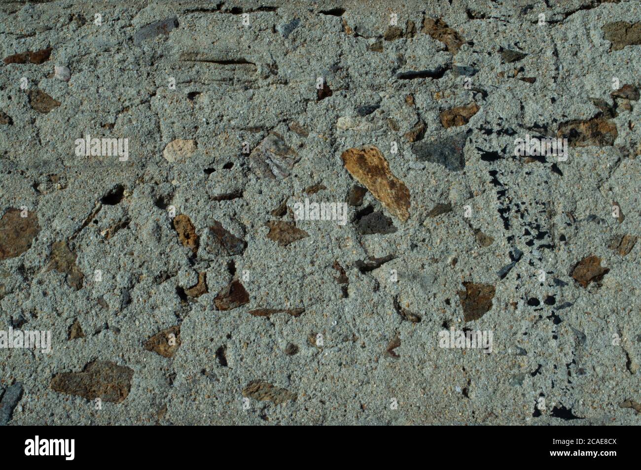 grunge texture concrete wall with pebbles abstract Stock Photo