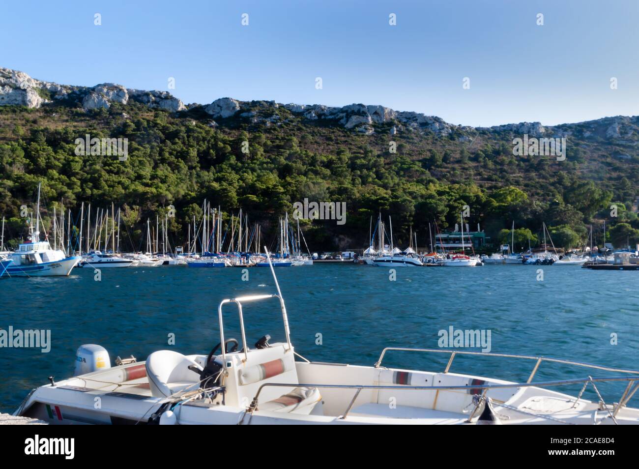 single boat docked at the pier float in the mediterranean sea Stock ...