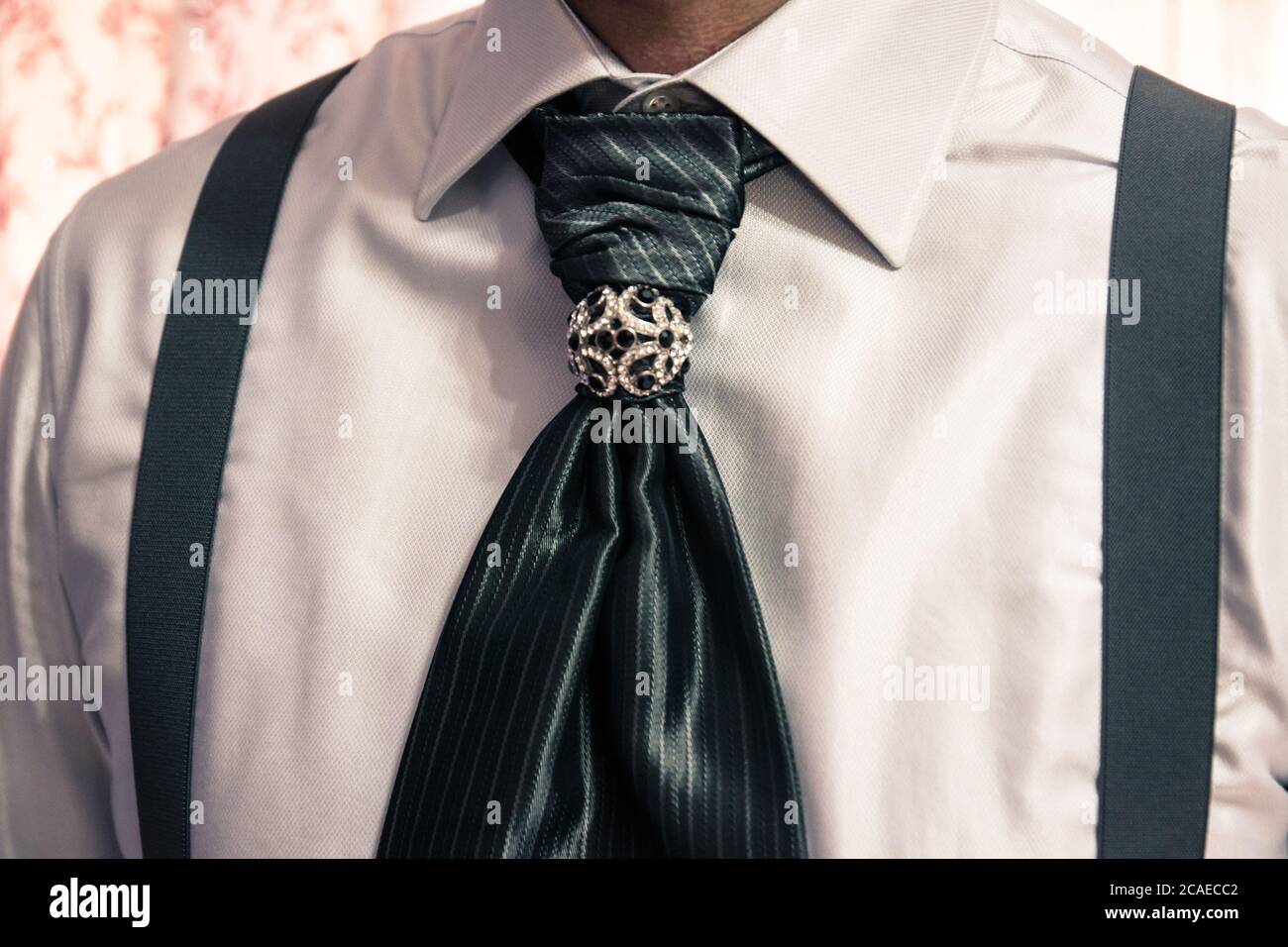Closeup shot of a groom wearing a striped tie Stock Photo