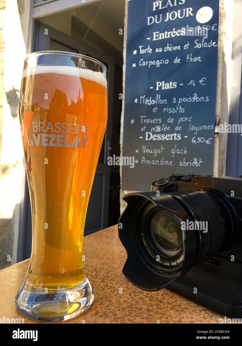 Digital camera and glass of beer, illustration for a photographer's way of life, Vezelay, Yonne, Bourgogne Franche-Comté, France Stock Photo