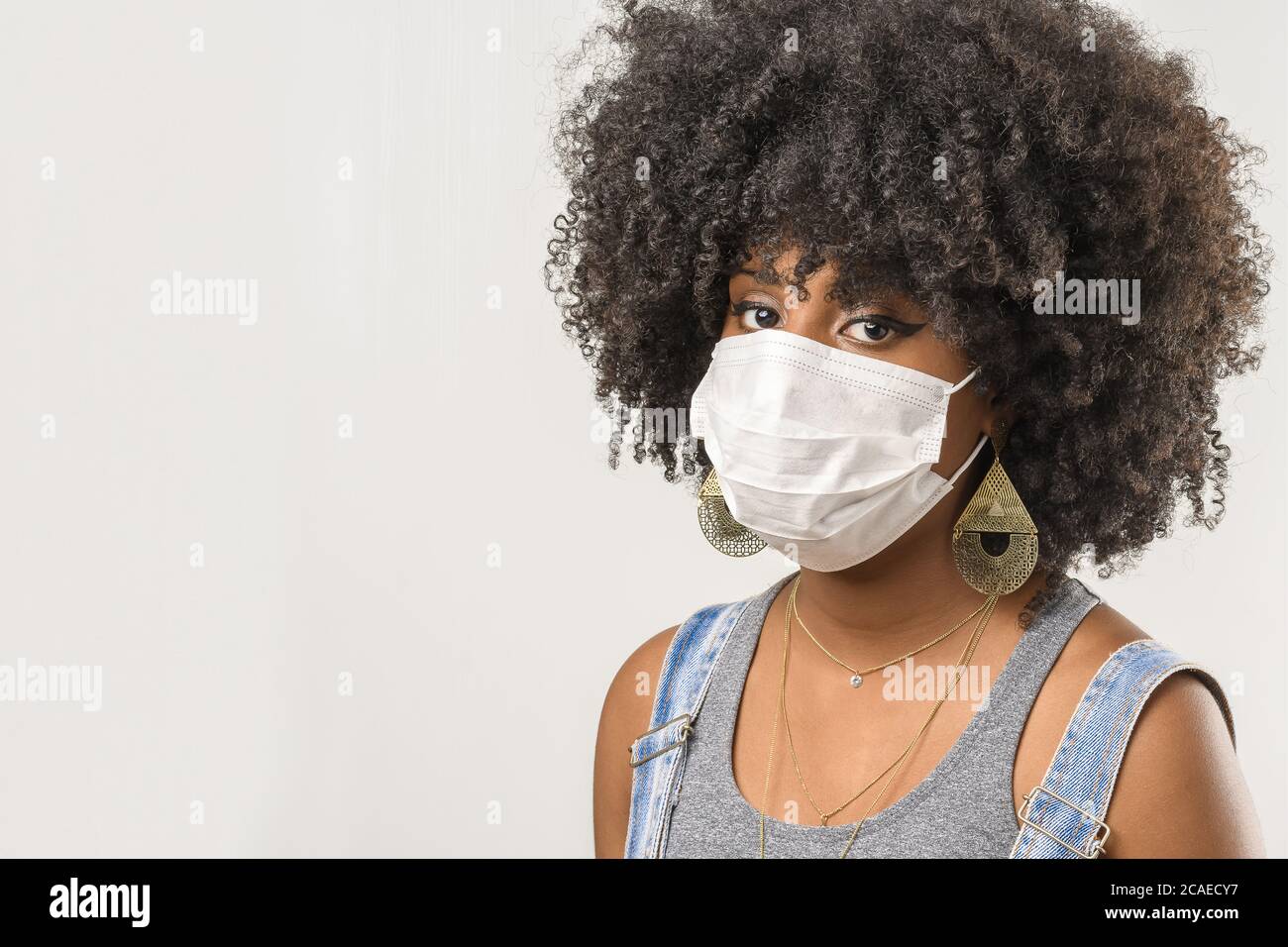young girl wearing protective mask in corona virus pandemic, covid-19 Stock Photo