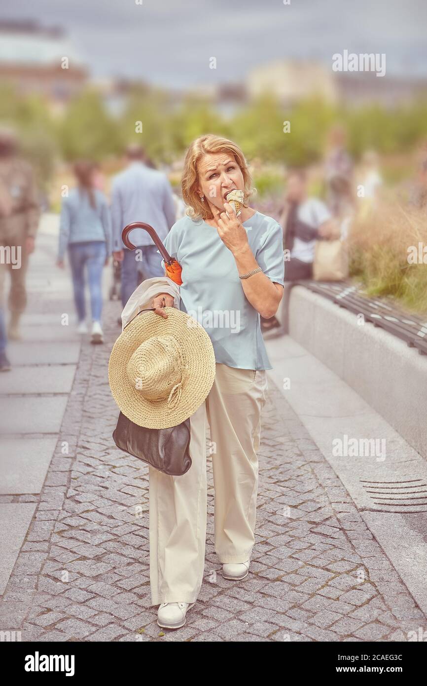 Elderly caucasian attractive woman about 60 years old is walking in the