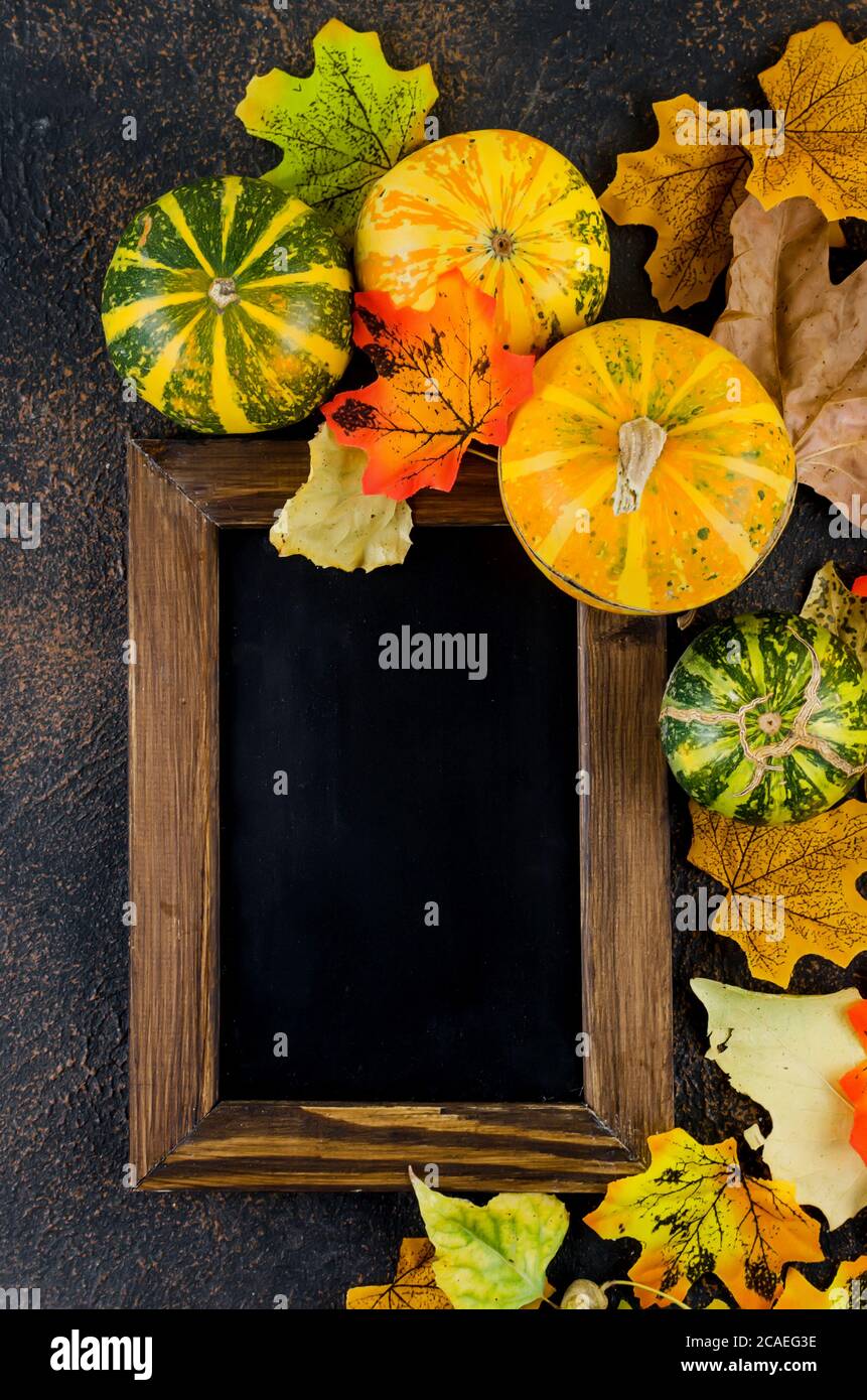 dark Autumn background with pumpkins, leaves, empty frame Stock Photo ...