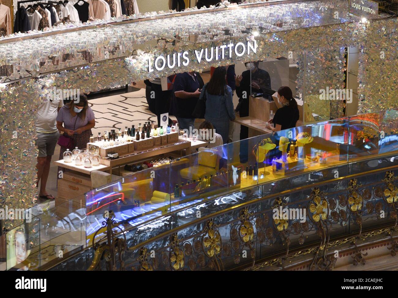 *** STRICTLY NO SALES TO FRENCH MEDIA OR PUBLISHERS - RIGHTS RESERVED ***August 03, 2020 - Paris, France: Clients with face masks against the coronavirus in a Louis Vuitton stall in the Galeries Lafayette megastore. Luxury brand stores in Paris are badly affected by Covid crisis, with wealthy tourists staying away due to travel restrictions and coronavirus fears. Vue sur un stand Louis Vuitton dans les Galeries Lafayette. Les boutiques de luxe font face a une chute de leur clientele traditionnelle du fait de la crise du Covid-19 et des restrictions de voyage. Stock Photo
