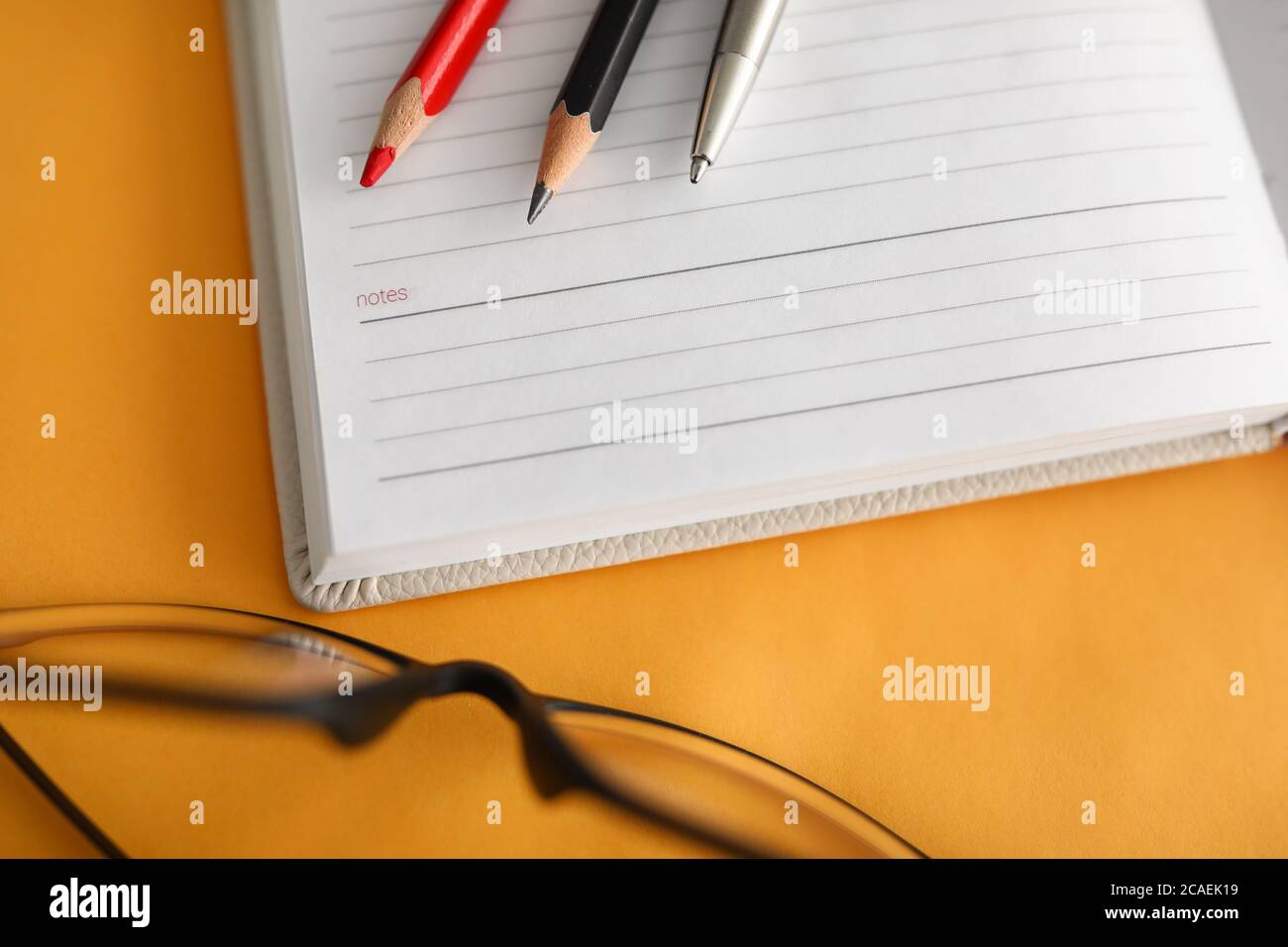 Blank notebook paper, pencil and glasses workplace Stock Photo