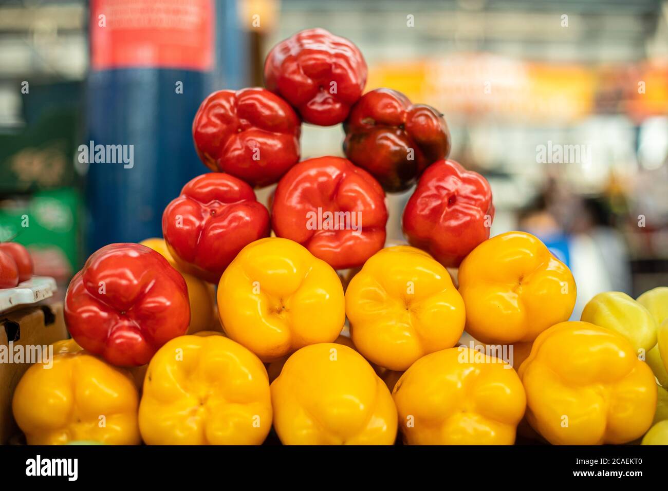 Red and yellow peppers arranged on the counter Stock Photo - Alamy