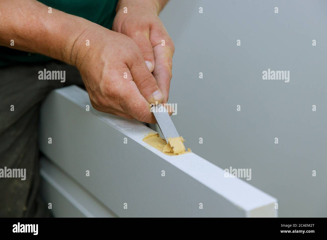 Wooden door installation of a hinge working with chisel prepared for mounting on a hinges Stock