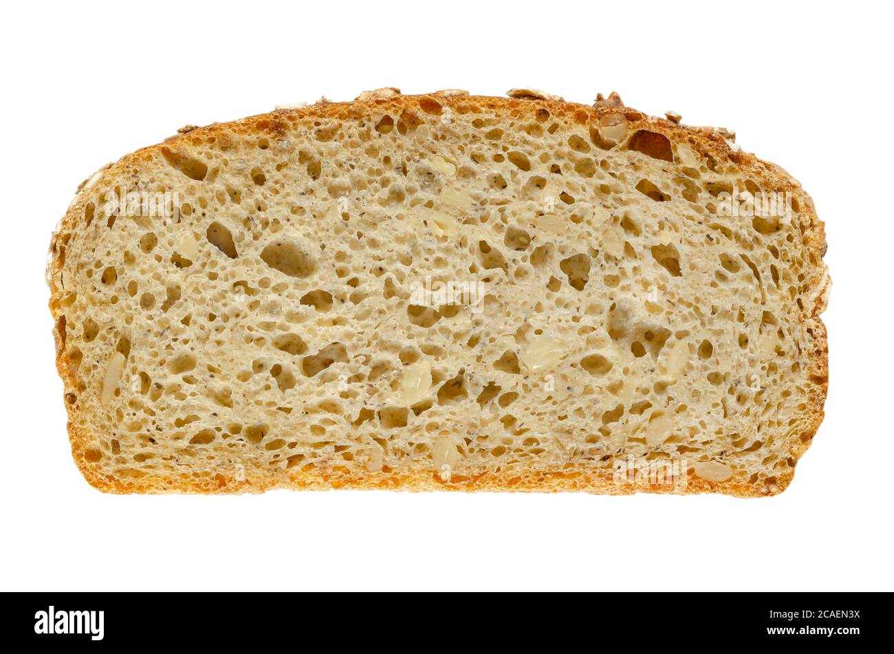 Slice of spelt bread, from above. Brown sourdough bread, a mix of spelt flour, leaven, sunflower seeds and spices, baked in oven. Staple food. Stock Photo