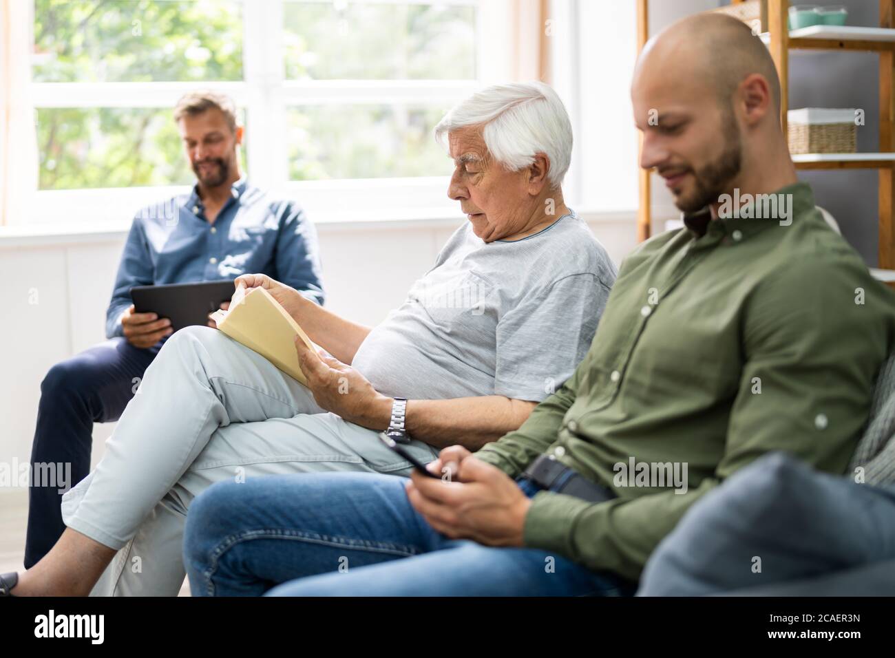 Three Generation Men Spending Time Together At Home Stock Photo