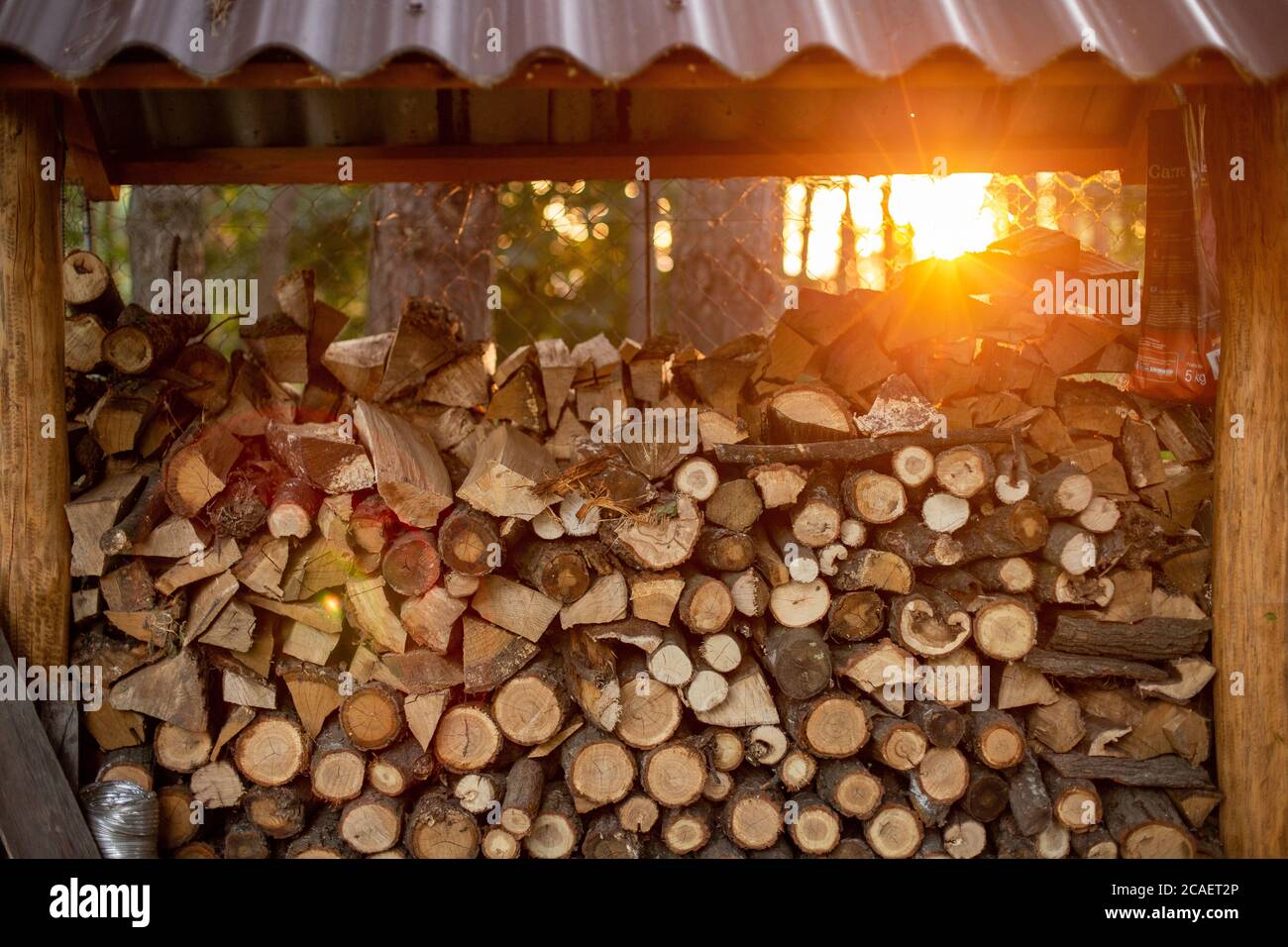Cut firewood stuck on each other in the firewood rack Stock Photo