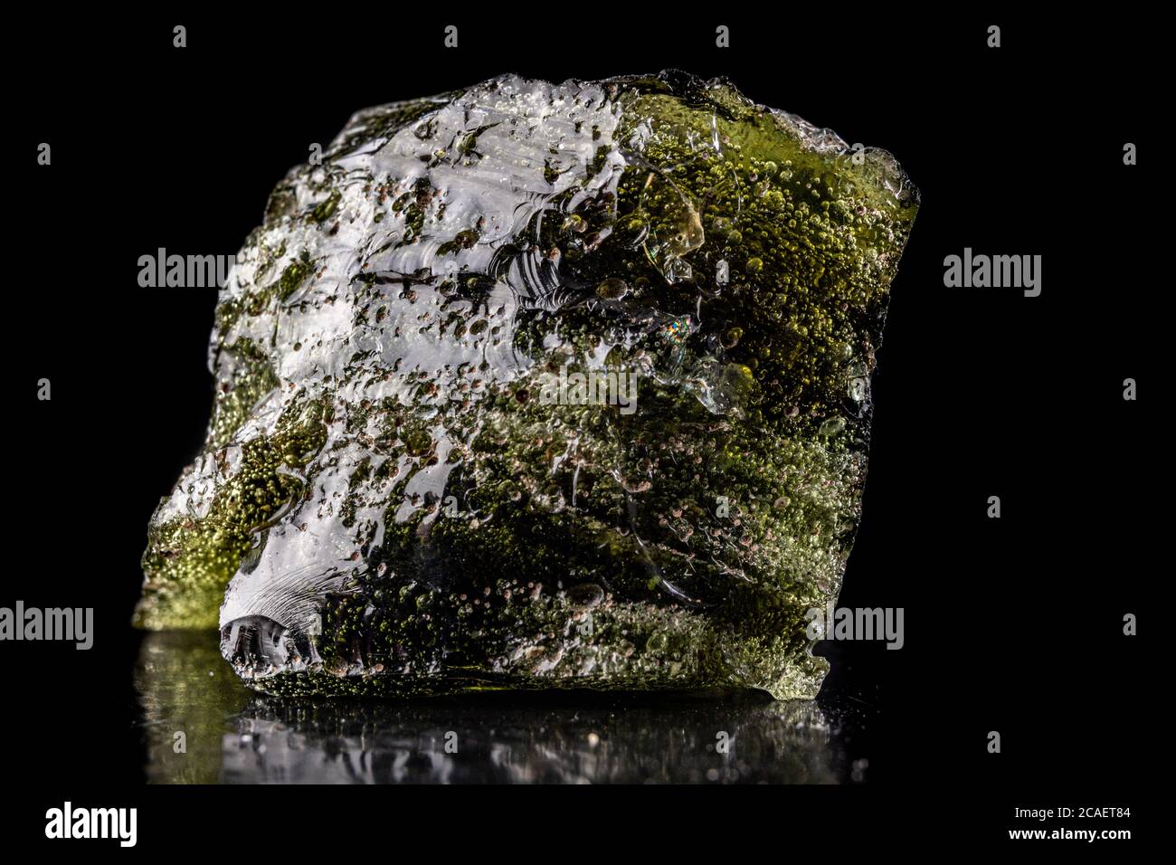 A piece of dark molten quartz with air bubbles. Melted sand in a glass
