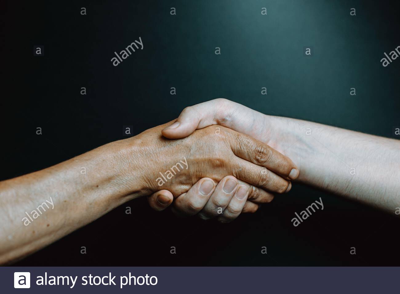 Old latina woman and young boy hand shaking hands Stock Photo