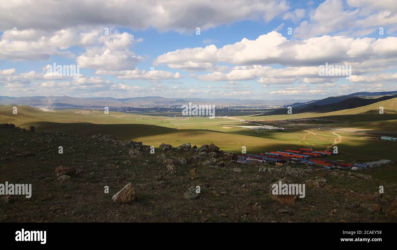 A view from the many hills of rural Mongolia, with sight of their capital city, Ulaanbaatar, in the distance Stock Photo