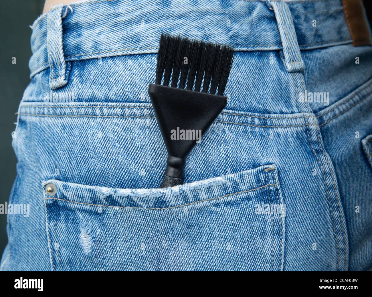 the hair dye brush is in the jeans pocket Stock Photo - Alamy