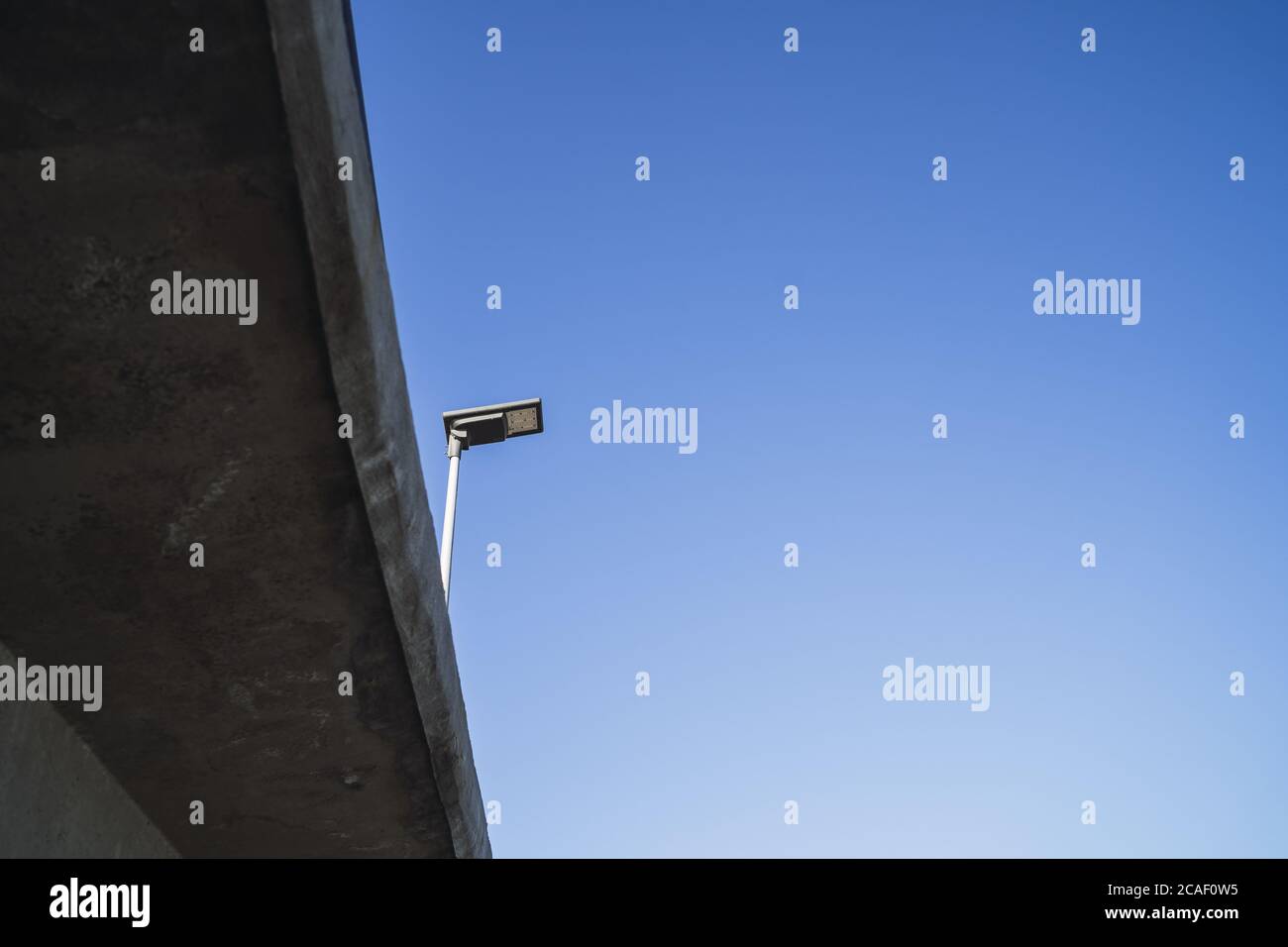 Low angle shot of street light with a blue sky background Stock Photo