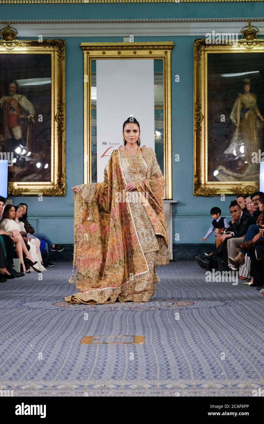 Model Fouzia Aman walks for Rana Noman at the Lifestyle London event showcasing Pakistani fashion design. Stock Photo