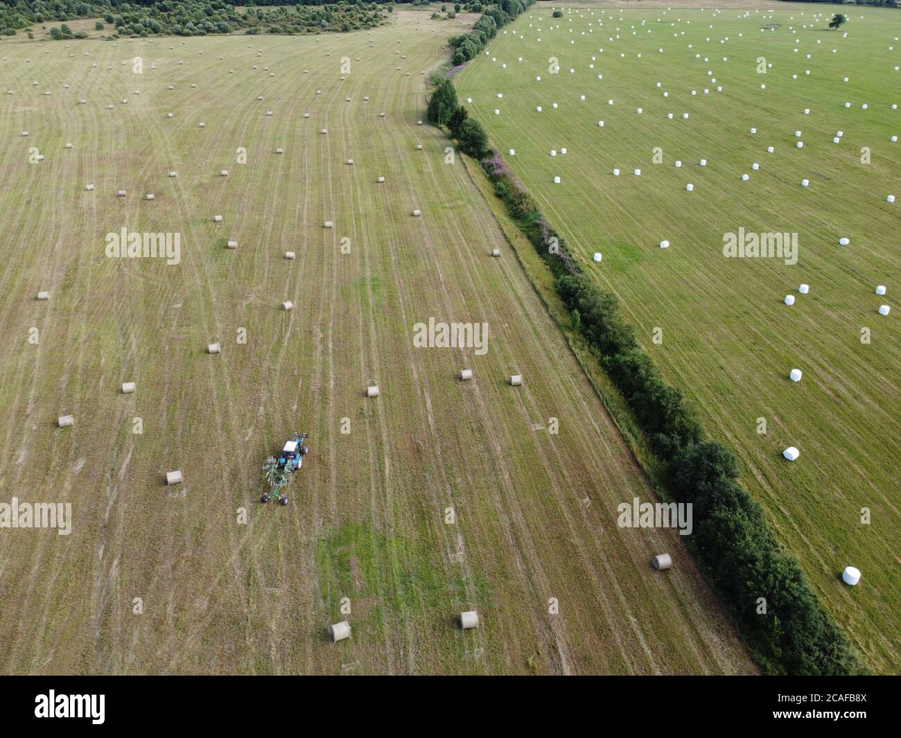 Tractor cultivating field at spring,aerial view Stock Photo - Alamy