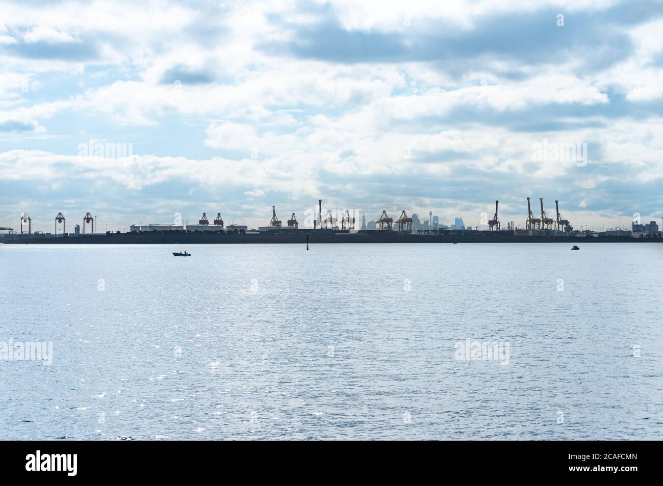 Sydney NSW Australia July 9th 2020 - View of Botany Bay Blue Water and Botany Port Cranes on a sunny winter afternoon Stock Photo