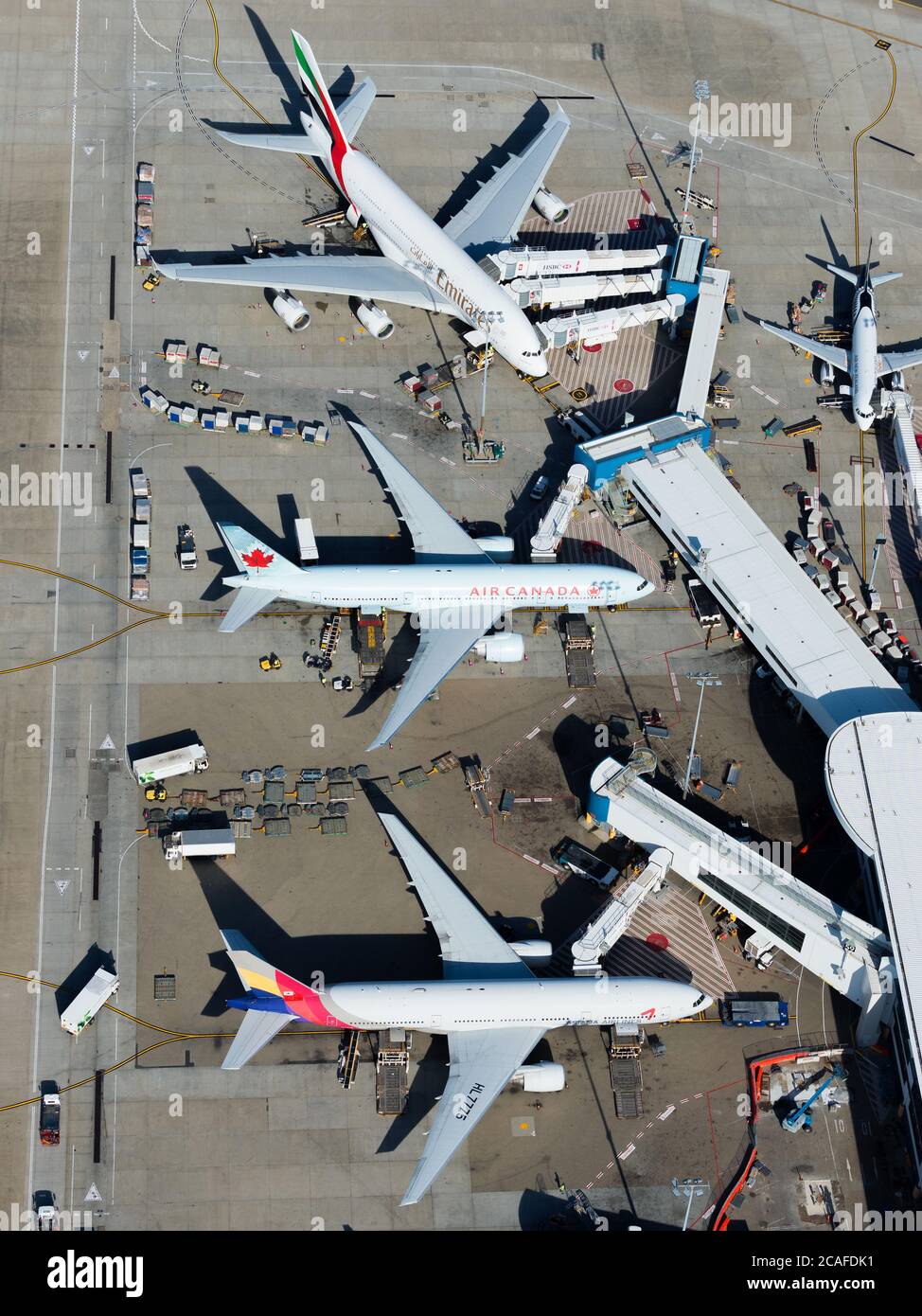 Aerial view of Sydney International Airport passengers terminal 1 busy with international flights. Aircraft parked at airport in Australia. Stock Photo