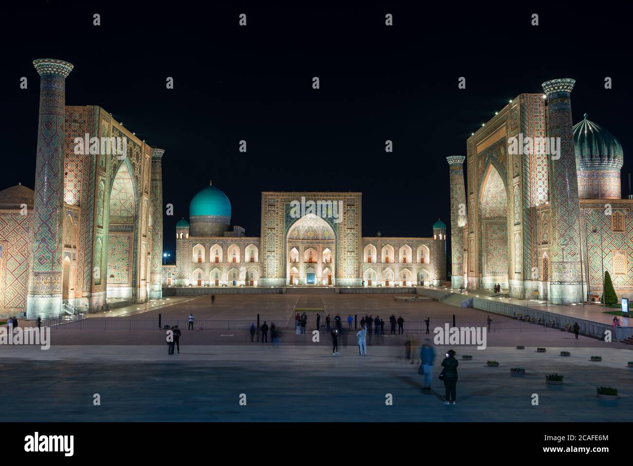 Registan Square in Samarkand, Uzbekistan at night. Madrasah Ulugh Beg, Tilya Kori and Sher Dor illuminated at night. Islamic architecture. Stock Photo